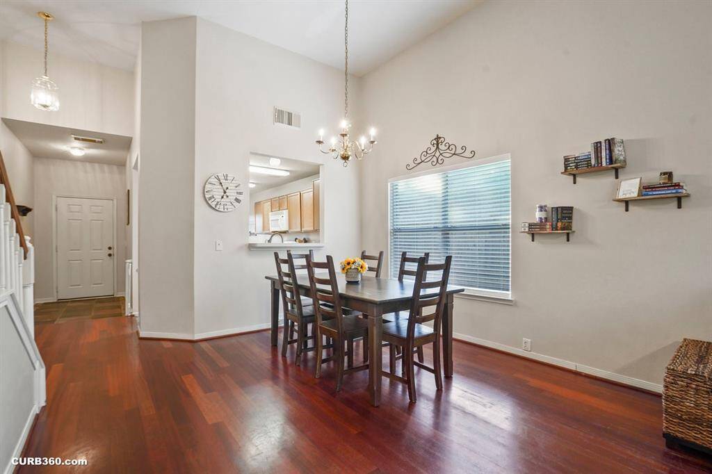 Welcome to your new home! This inviting space features elegant hardwood floors and a bright, open dining area perfect for entertaining. The seamless flow into the kitchen enhances the home's charm and functionality.