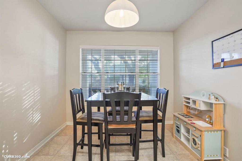 Bright and inviting living area featuring high ceilings and elegant hardwood floors. Enjoy the spacious open layout with a cozy dining space and a comfortable lounge area, perfect for entertaining or relaxing. Large windows offer ample natural light.