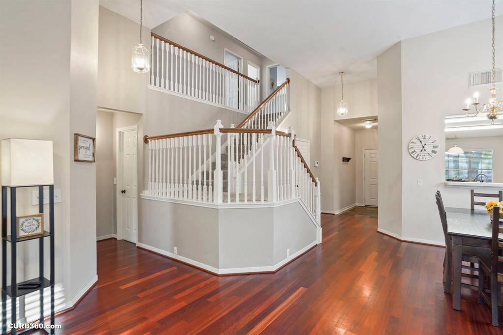 Step into a welcoming home with elegant hardwood floors and an open staircase, creating a bright and inviting atmosphere. Perfect for entertaining, this space combines style and functionality effortlessly.