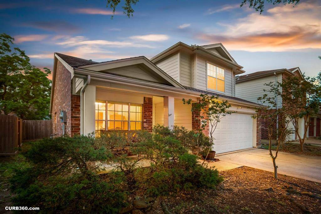 The large windows allow for an abubndance of natural light, while the backyard and mature trees creates a serene outdoor escape.