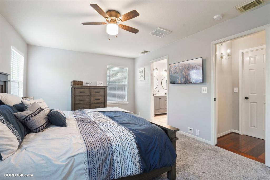 Experience modern elegance in this beautifully designed bathroom, featuring a sleek walk-in shower with exquisite marble tile and a stylish vanity with ample storage. Perfect for relaxation and functionality.