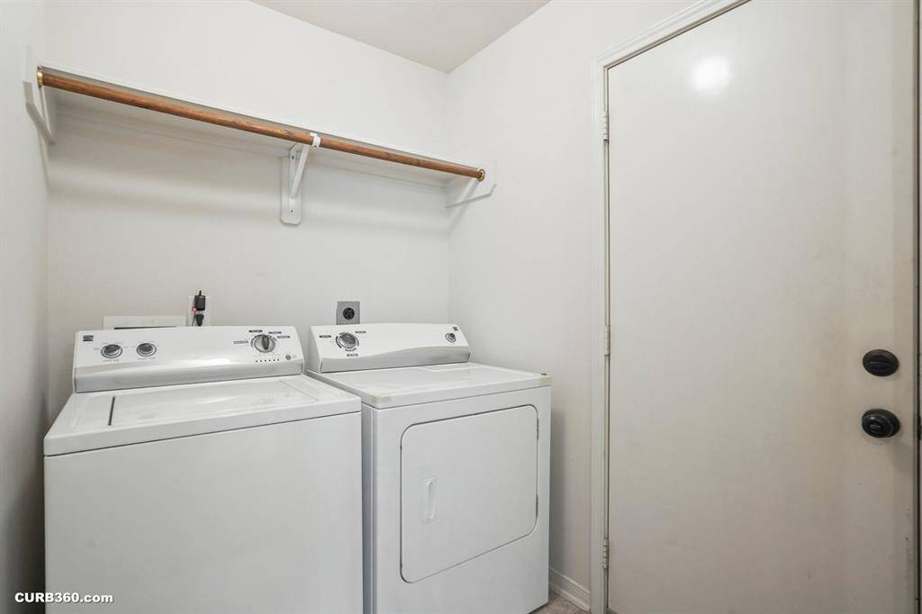 Convenient laundry room with washer, dryer, and extra storage space. Perfect for efficient household chores.