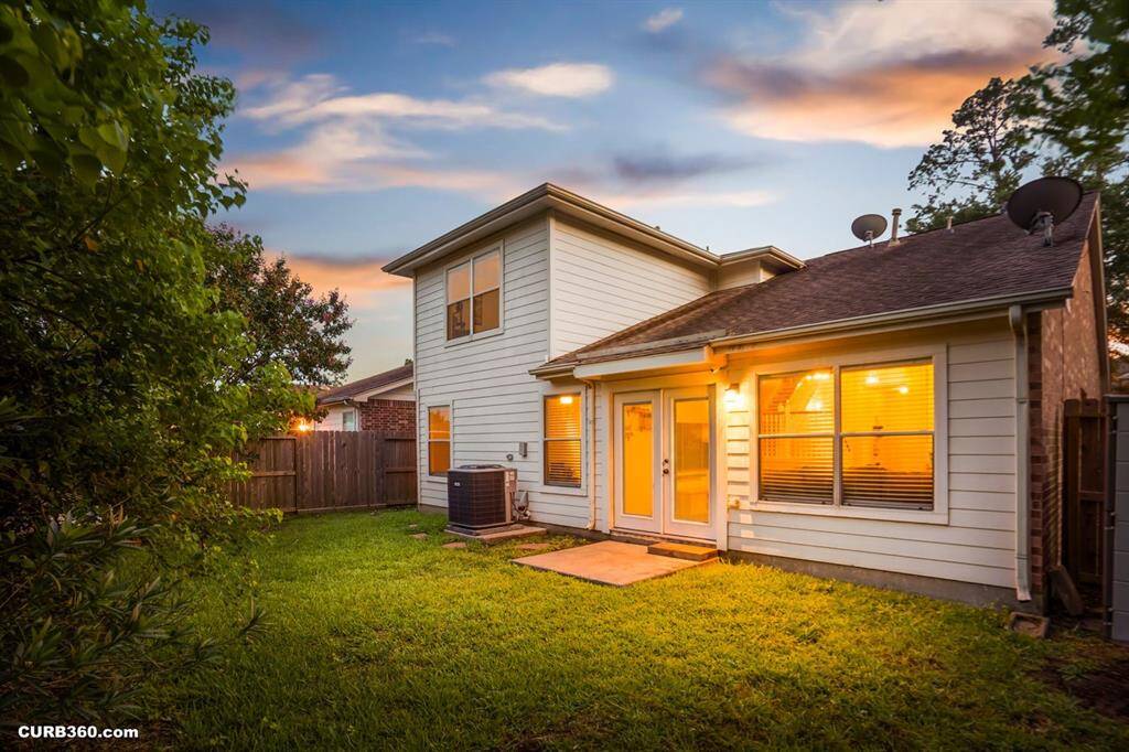 Discover this charming home featuring a spacious backyard, perfect for relaxation and entertaining. The warm glow from the windows complements the serene setting, offering a welcoming atmosphere. Ideal for those seeking comfort and tranquility.