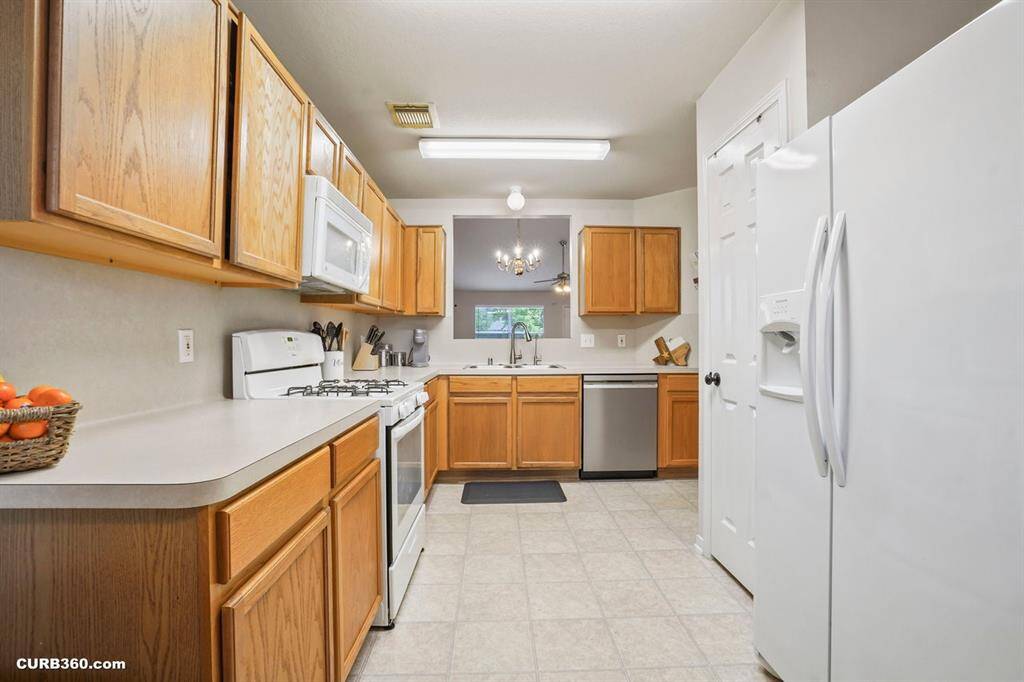 Modern kitchen with ample storage, updated appliances, and a bright, open layout. Ideal for cooking and entertaining.