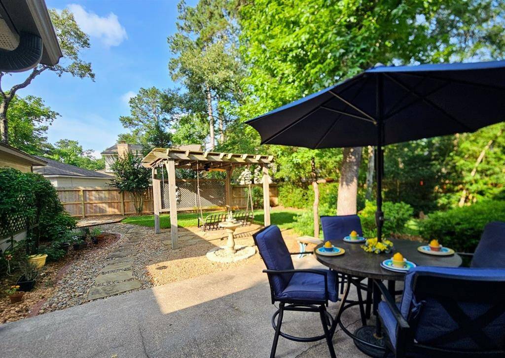Absolutely stunning, welcoming and tended garden and backyard area.  Enjoy sounds of water trickling while sitting in the pergola or back porch area. All types of birds enjoy this yard. Entire yard front, sides, back offer mature azaleas.  Very shaded with healthy trees, gutters on home, bullrock surround as well. Meticulously maintained!  Large space at side of garage for storage shed, butterfly staging area, gardening.