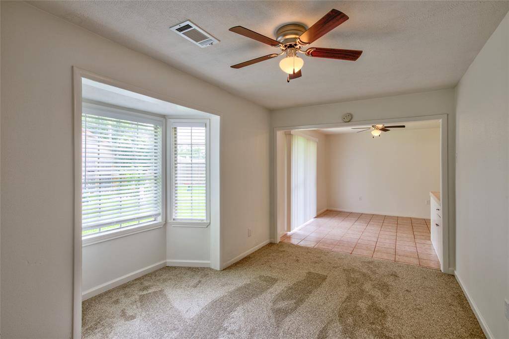 The home features a cozy small den conveniently located next to the kitchen, adding versatility, to the living space. This den is the only room in the house adorned with carpet, providing a soft and inviting atmosphere that contrasts with the other hard surface areas.