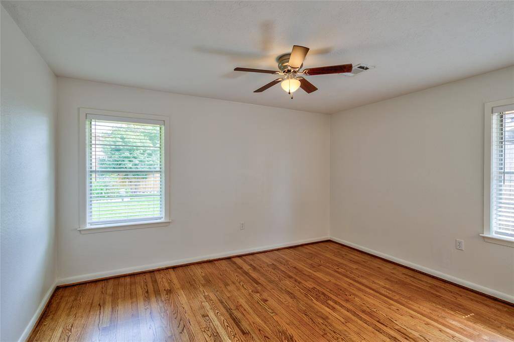 The primary bedroom is a serene retreat featuring the same elegant white oakwood flooring that flows throughout the home, enhancing its warmth and charm.