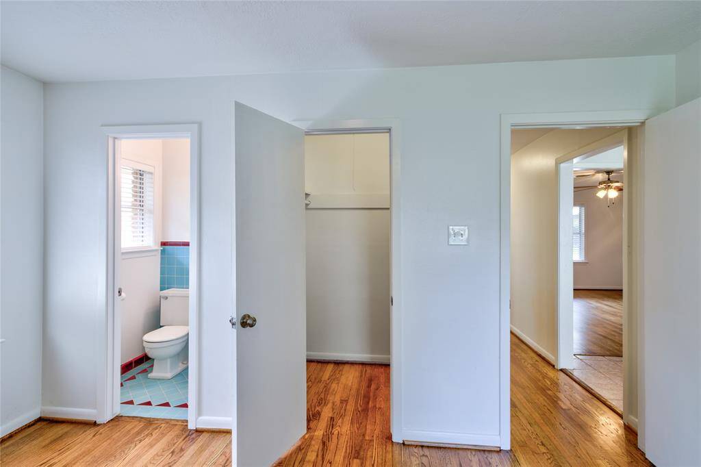 Spacious primary room featuring an en-suite bathroom and beautiful solid white oak-wood floors.