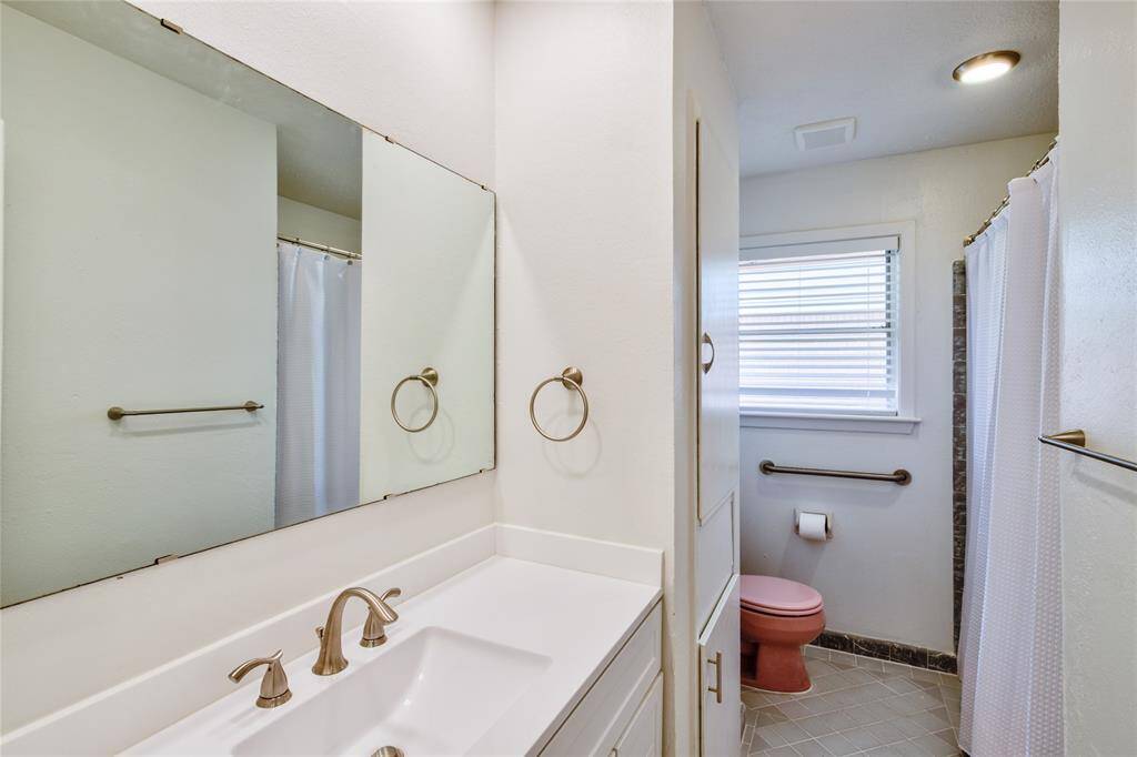 The combination of the new vanity and the vintage tub creates a harmonious blend of old and new, offering a comfortable and inviting atmosphere for relaxation.