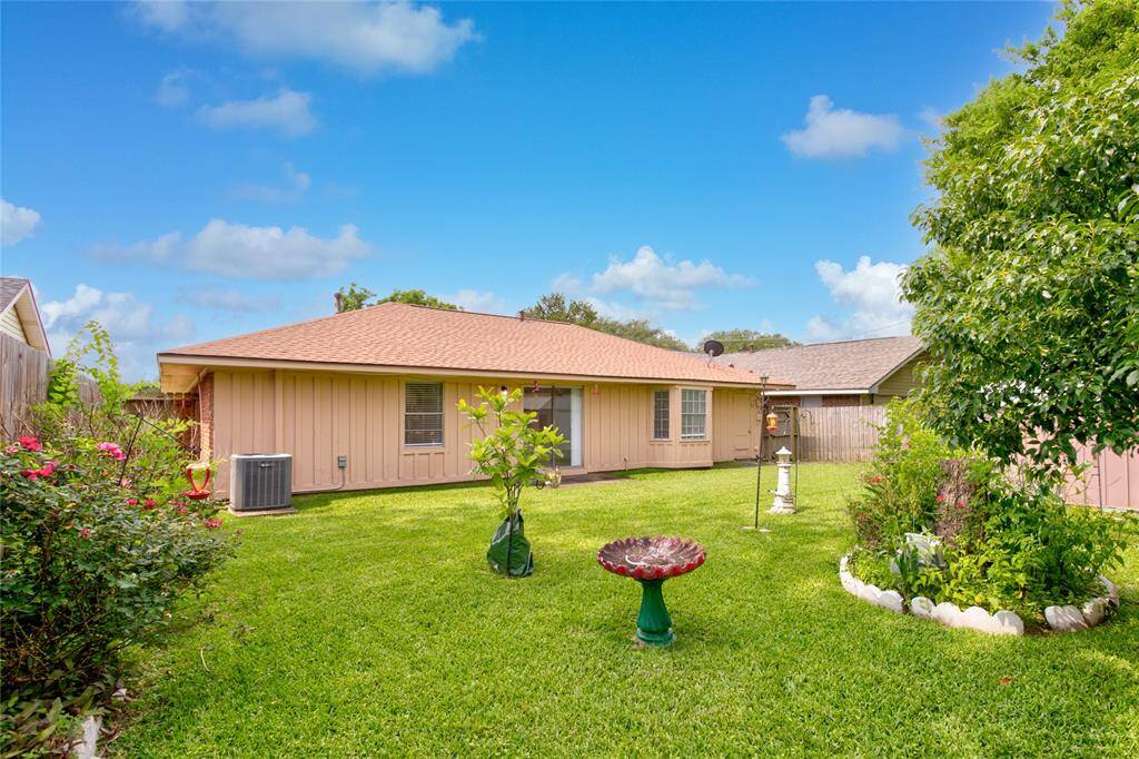 Discover a spacious, well-kept backyard perfect for relaxation and activities, featuring a lush lawn ready for gardening, play, or peaceful afternoons.