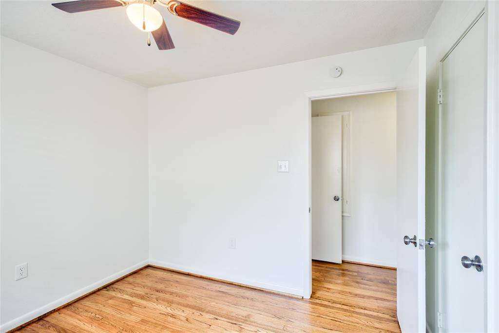This elegant second room, located just beyond the first in the hallway, features beautiful solid white oak-wood  flooring throughout.