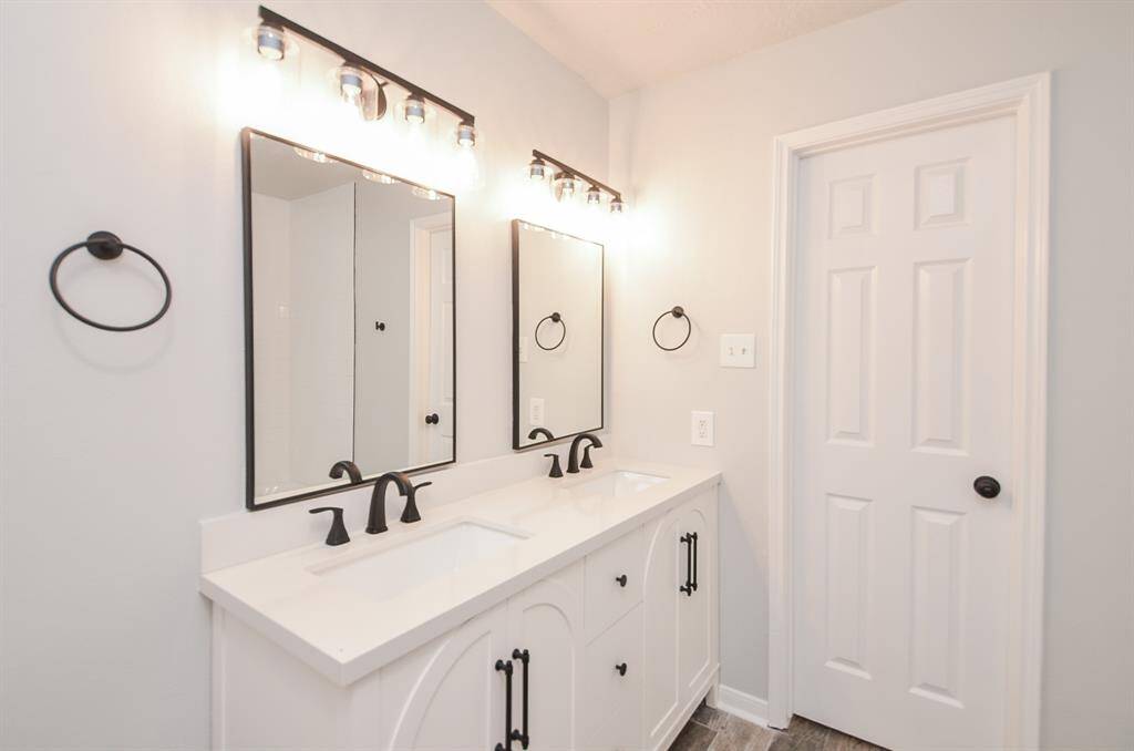 Beautiful classic hardware offsets the arched cabinet doors