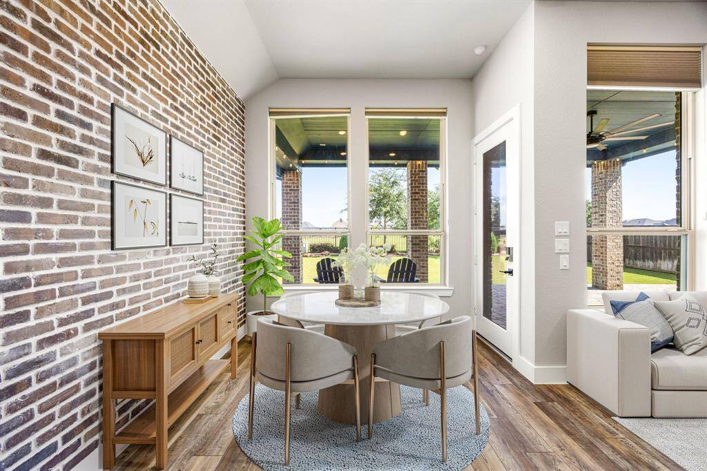 Start your day off right with a cup of coffee sitting with your family in the lovely breakfast area! Featuring large windows, stunning brick feature wall, vinyl plank flooring, recessed lighting and high ceilings.