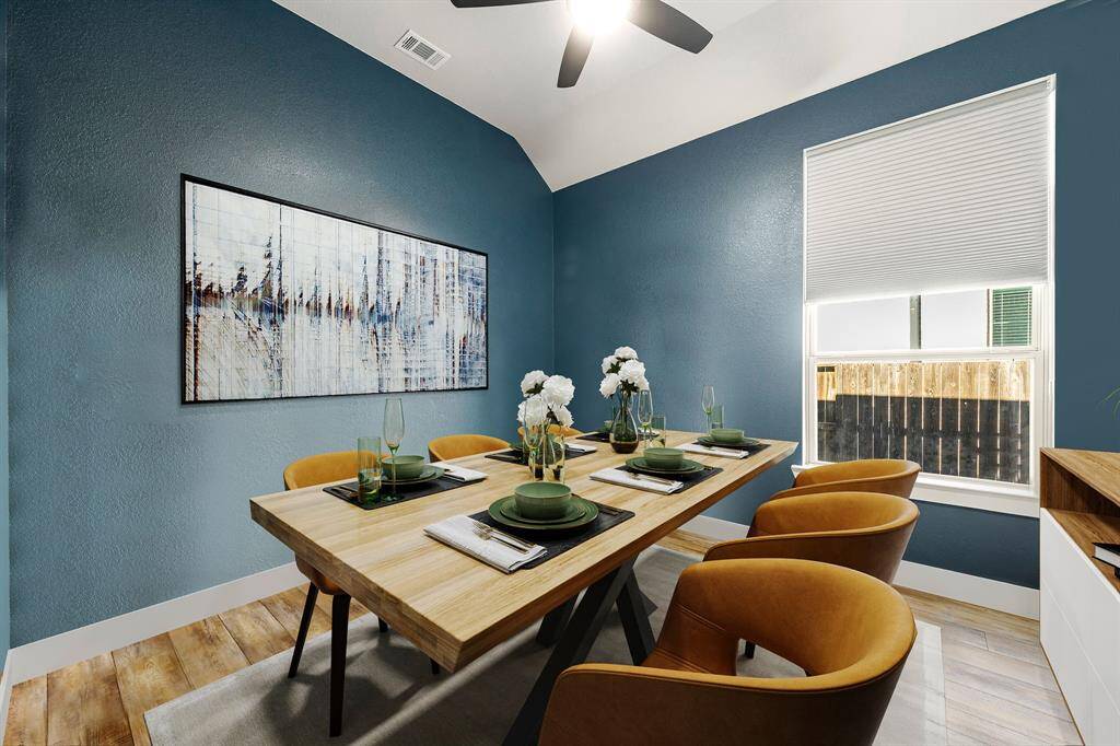 Make memories gathered around the table with your family and friends! This dining room features raised ceilings,  large windows, custom paint, warm vinyl plank floors and fan with lighting.