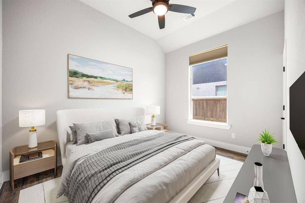 Secondary bedroom features rich vinyl plank floors, neutral paint, dark stained ceiling fan with lighting and a large window with privacy blinds.