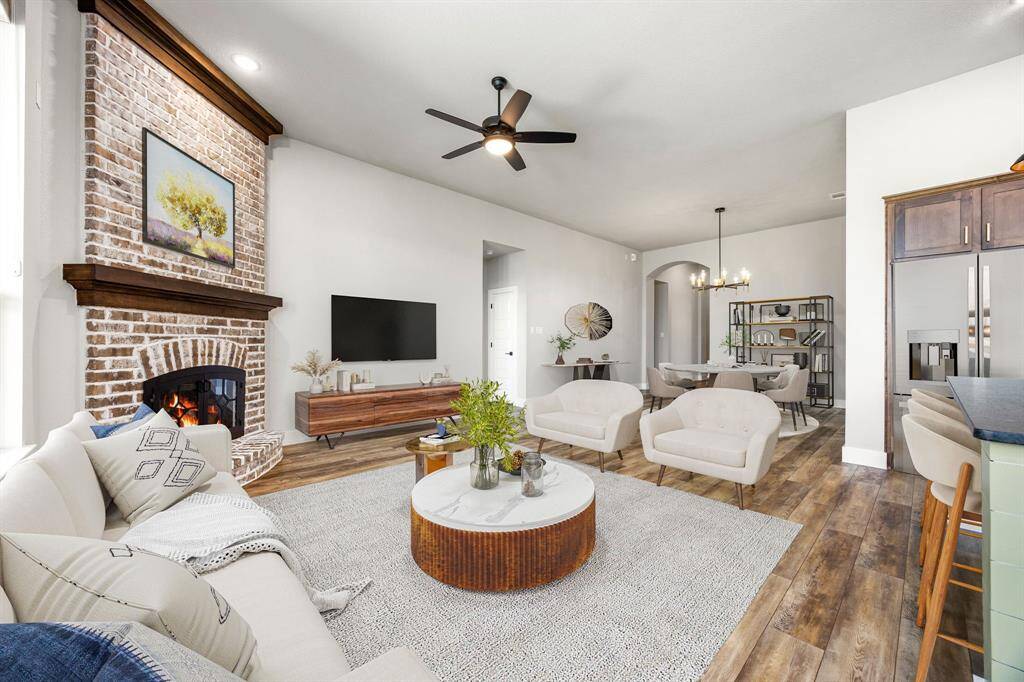 This light and bright spacious living room is the perfect layout for entertaining or just relaxing. Whether it's simply a night in or entertaining family and friends, this home has ample open space for everyone to enjoy! Featuring dark stained ceiling fan, rich vinyl plank flooring, large windows, soaring ceilings, recessed lighting with wonderful access to your gorgeous kitchen.