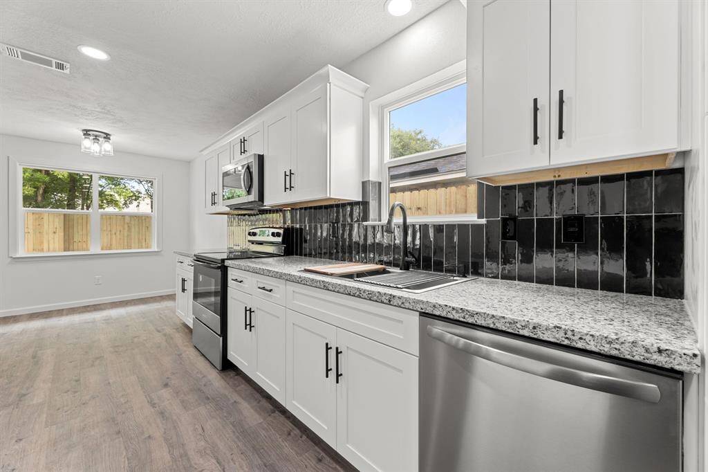 recessed lighting and new cabinets with stylish hardware
