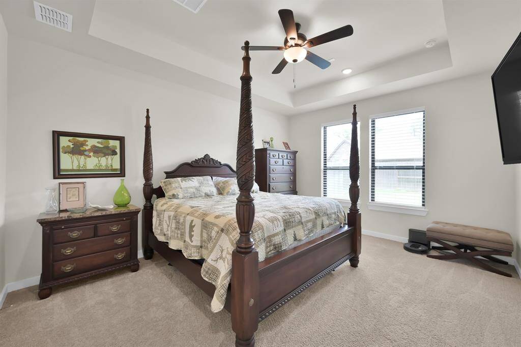 Spacious bedroom with natural light.