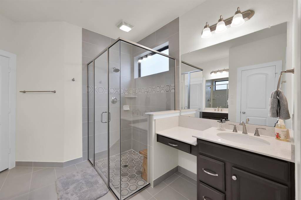 Spa-like bathroom with spacious glass-enclosed shower.