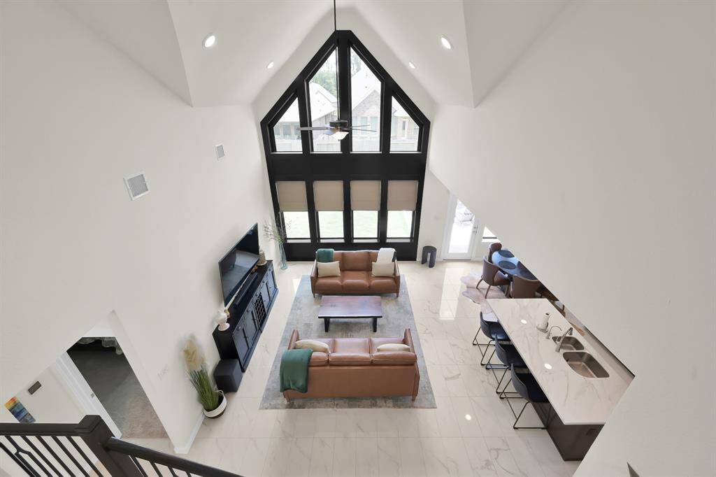 Open staircase view with elegant lines and grand lighting!