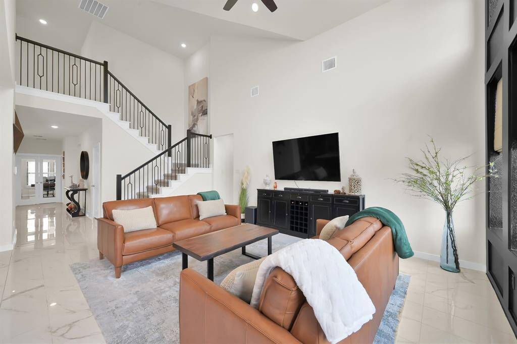 Open concept layout with grand staircase.
