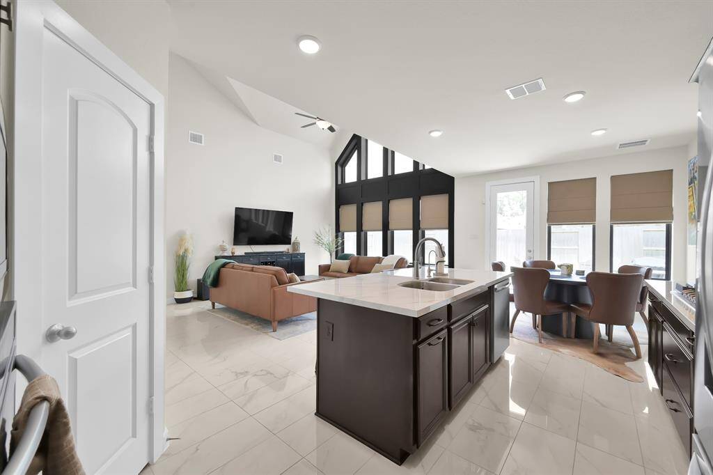 Island kitchen with stainless steel appliances brings a chef's dreams to life.