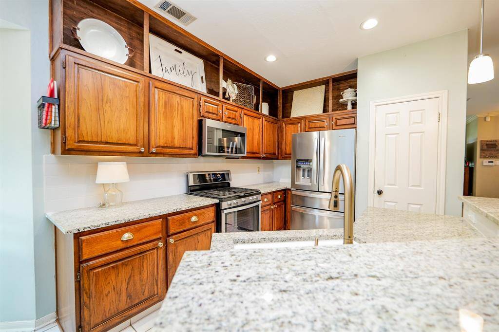 Open shelving above cabinets adds room for décor.