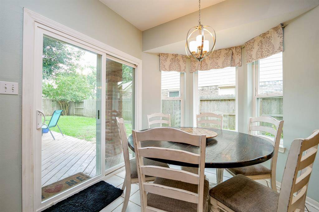 Bay windows and large back door provide natural light in breakfast area.