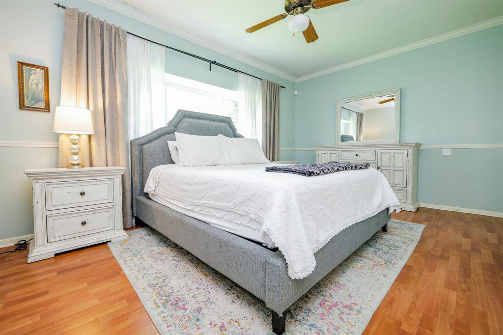 Primary bedroom is spacious and filled with natural light.