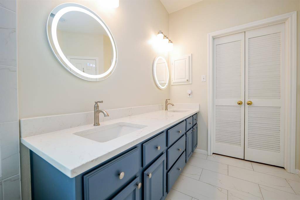 Primary bath is remodeled with new vanities and dimmable lighted mirrors.