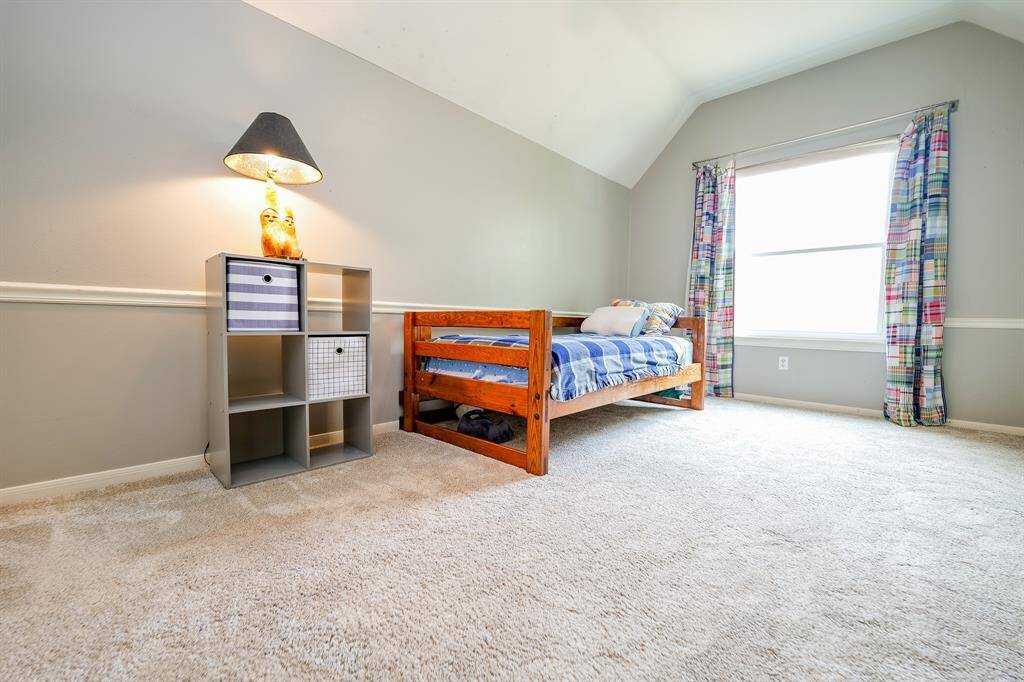 This versatile bedroom space features chair rail moding.