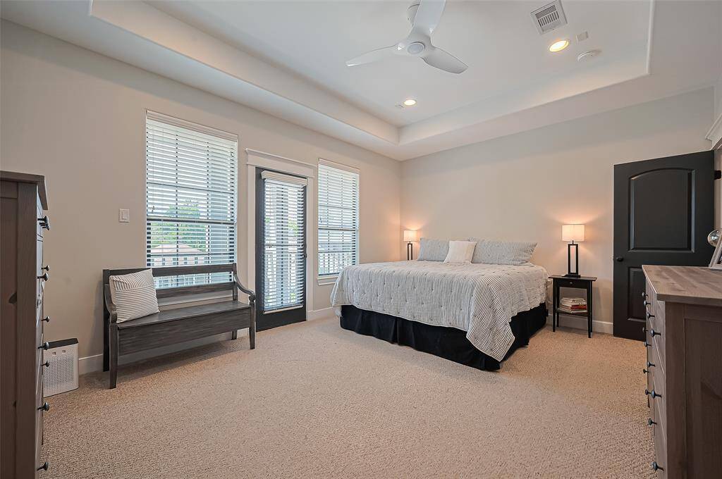 Very large primary bedroom with a door leading to a juliet balcony