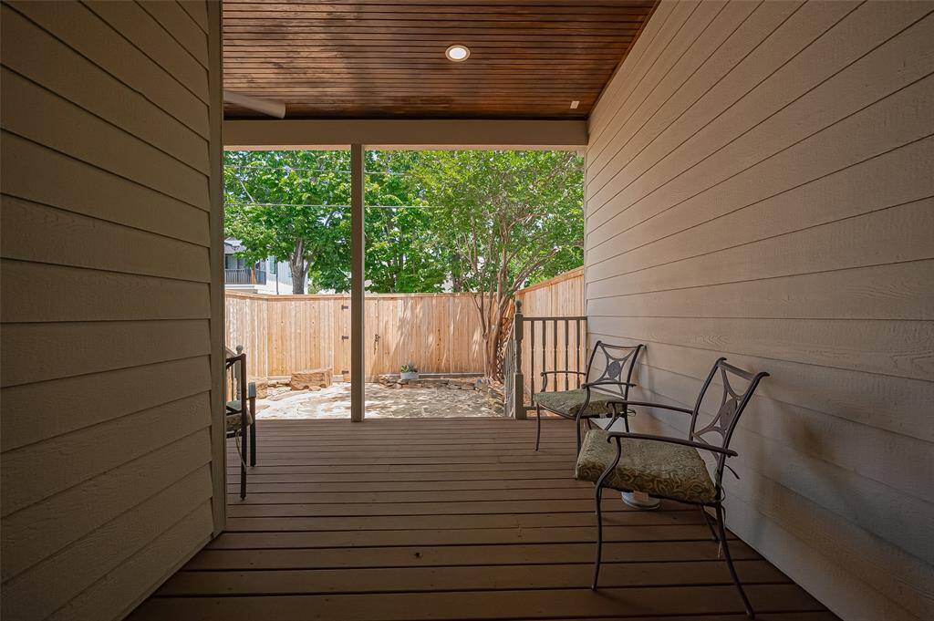 As you first walk out to the back yard featuring a large wooden covered patio