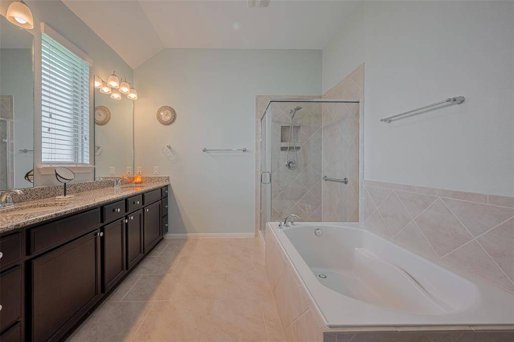 Stylish tilework and a spa-inspired layout elevate this ensuite bath, combining function with timeless appeal.