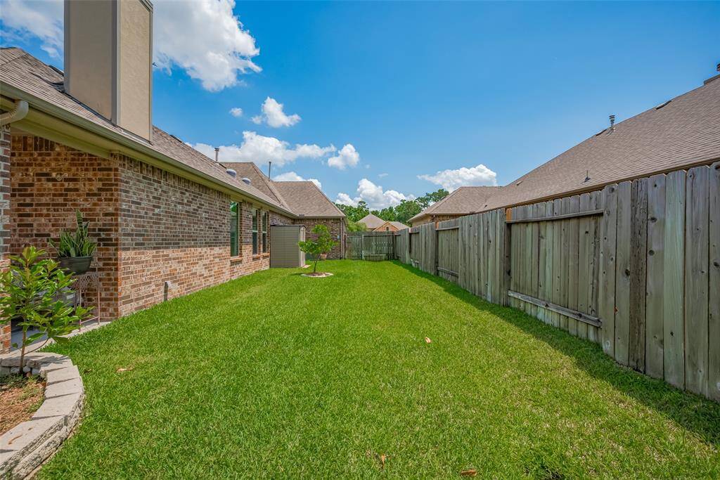 A private side yard runs the length of the home, offering extra green space and access to a storage shed.