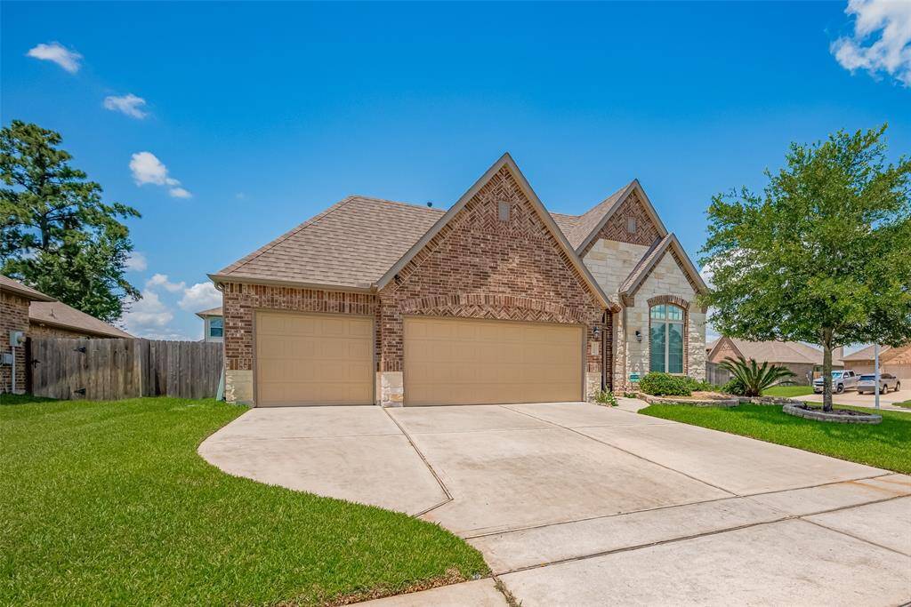 Beautifully maintained exterior with manicured landscaping, mature tree, and welcoming presence.