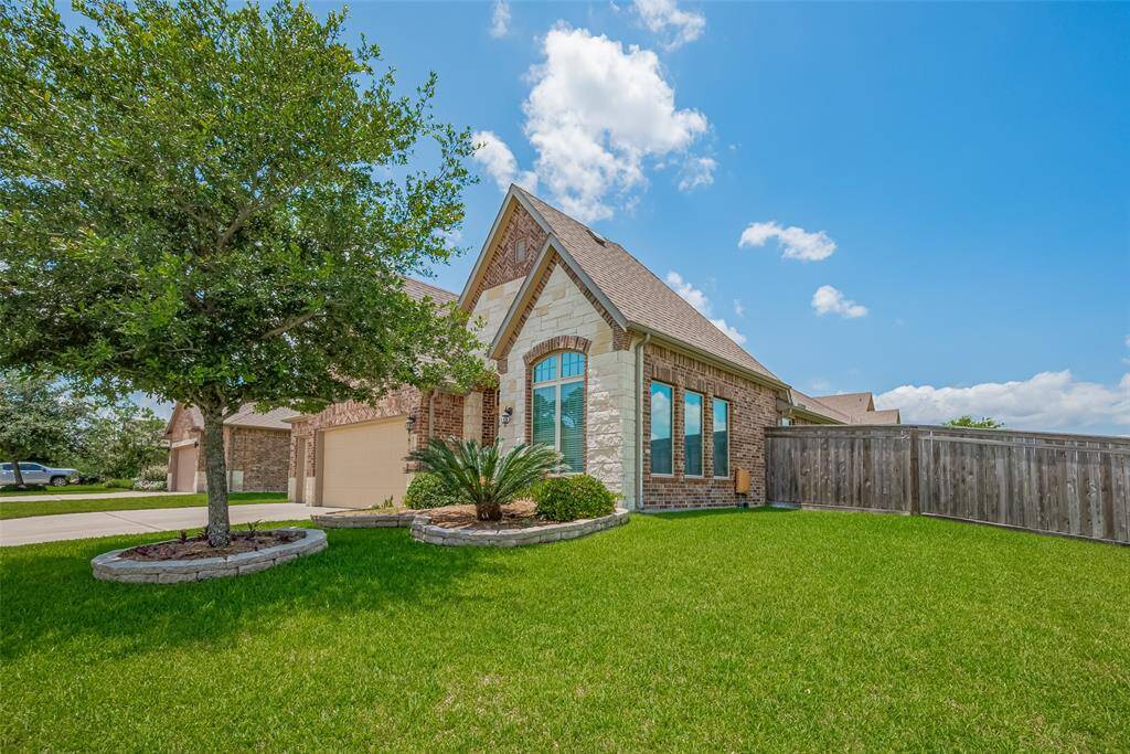 With its striking rooflines, stone accents, and tall arched window, this home is a can't miss!