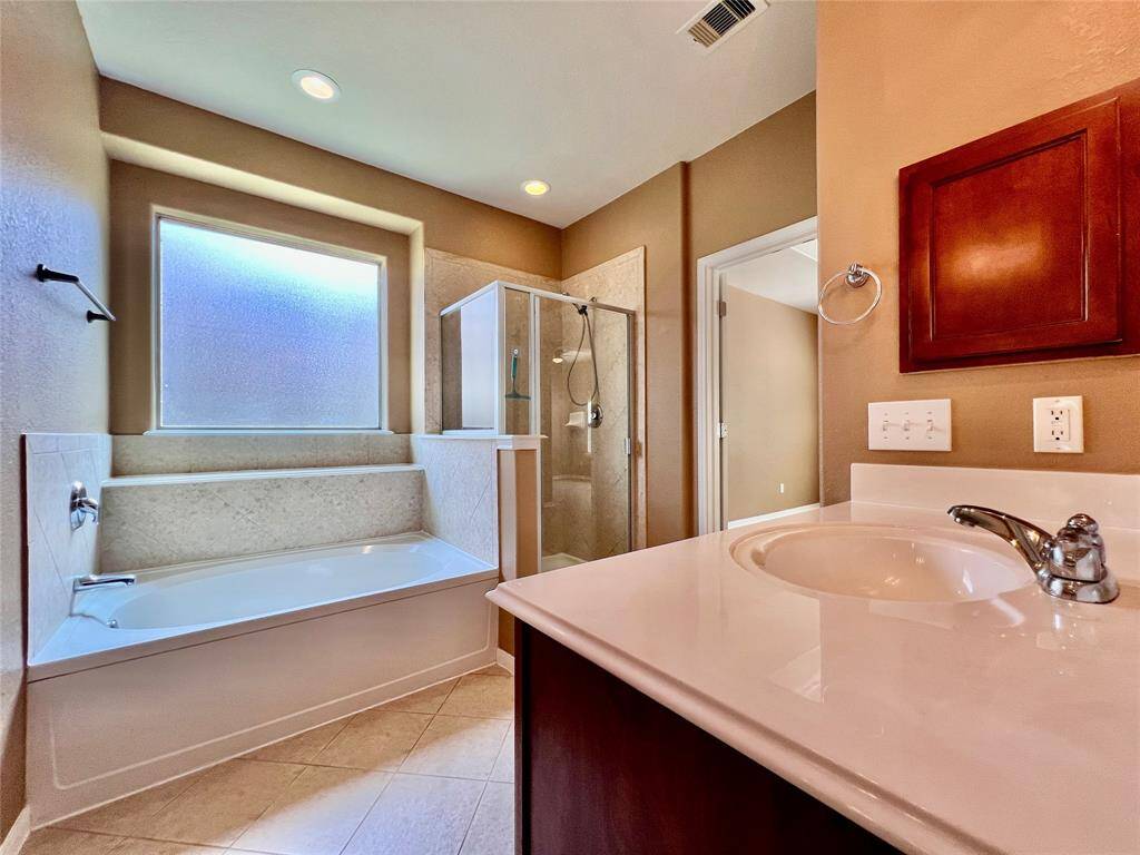 Primary Bedroom Suite with Double Sinks, Separate Shower, Soaking Tub, and  a good size Walk-in Close