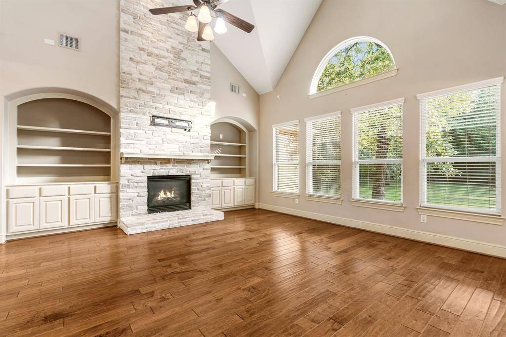 Living with floor to ceiling stone fireplace and nice storage.