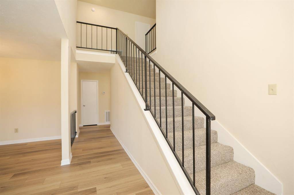 stairs to 2nd floor with secondary bedrooms