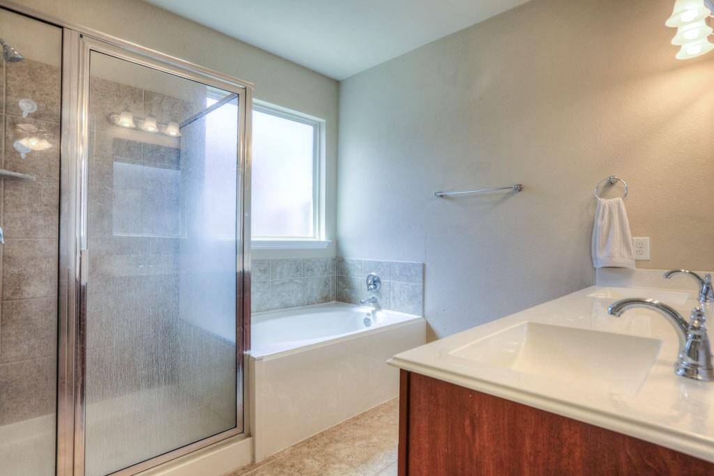 Primary bath has a garden tub, shower, double sinks & a large walk in closet.