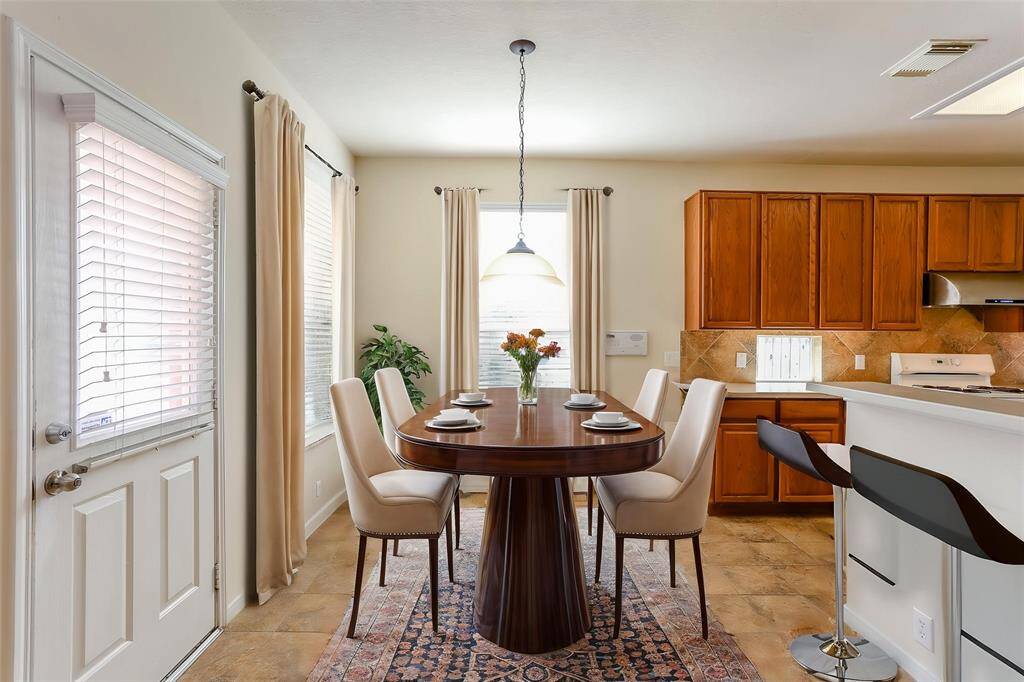 THE LIGHT FILLEDBREAKFAST AREA HASACCESS TO THE BACK PATIOAND IS A GREAT SPOT FOREARLY MORNING MEALS. **This room has been virtually staged.