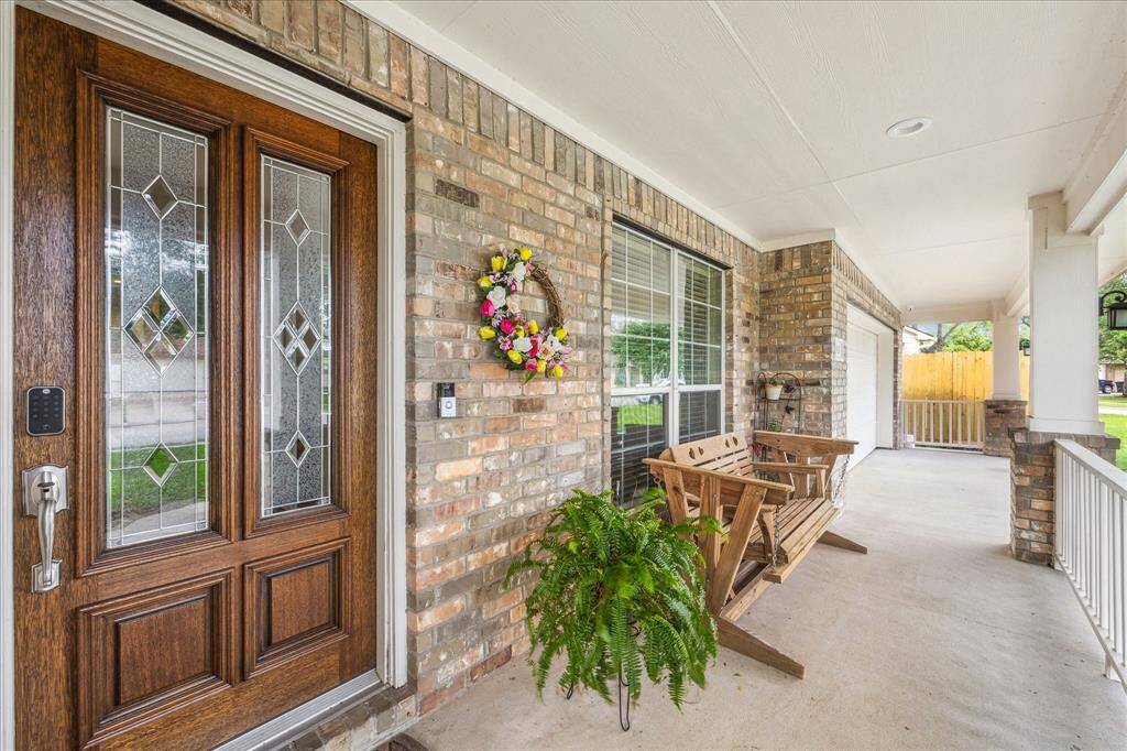 Charming front porch with a brick exterior. Ideal for relaxation and welcoming guests.