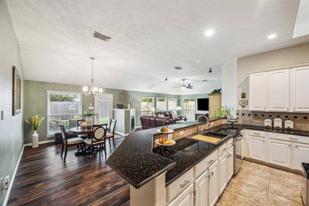 This huge modern kitchen with granite countertops features a 15 foot bar open to the 2nd living area and breakfast room.