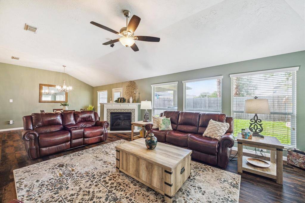 This inviting family room features a vaulted ceiling with a remote controlled ceiling fan and a surround sound speaker system that is included.