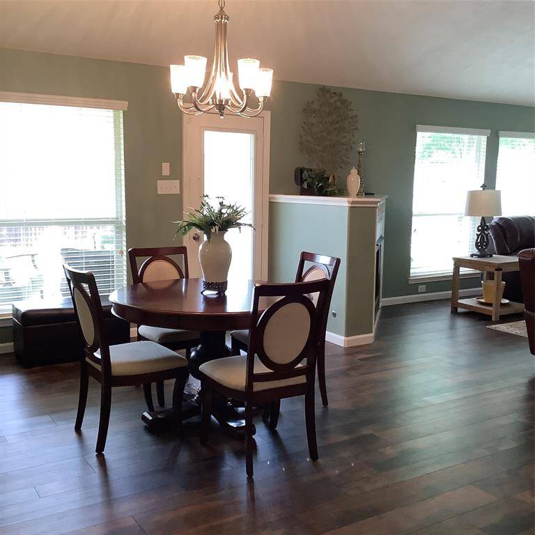 This primary bedroom has a stylish chandelier that is also a ceiling fan. You will love cozy sitting area.
