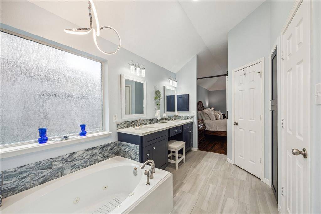 Check out the 20K up-graded primary bathroom.  It features a large jetted tub and elegant lighting.