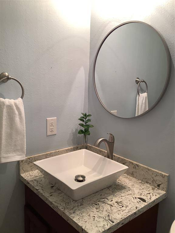 Updated hall bath has a shower with a seat.