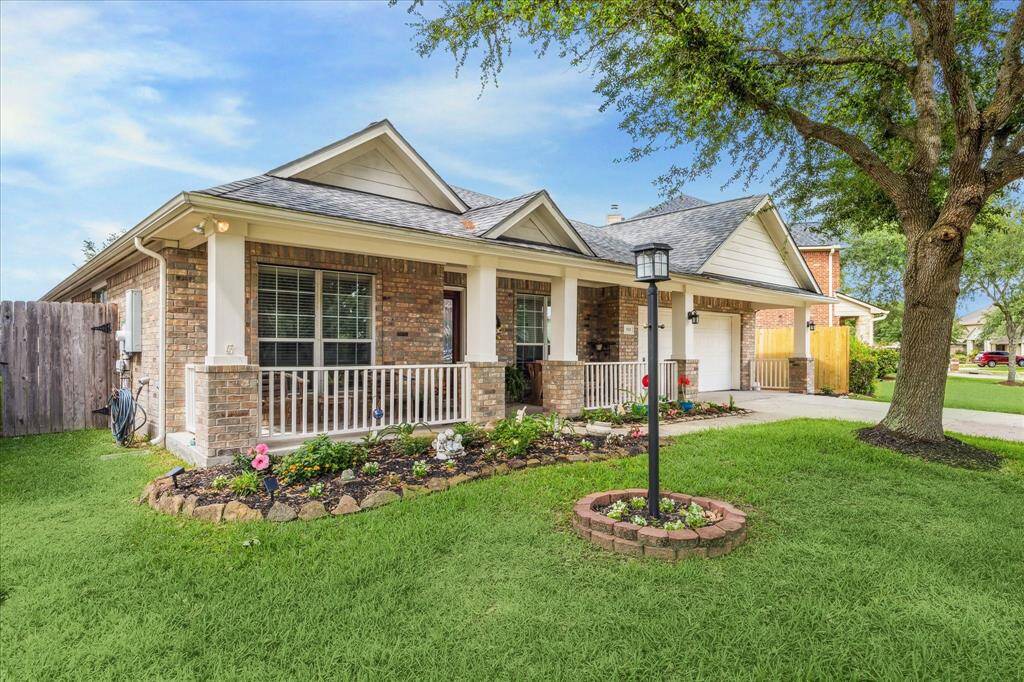 Charming single-story brick home with  well-maintained landscaping and mature oak trees.