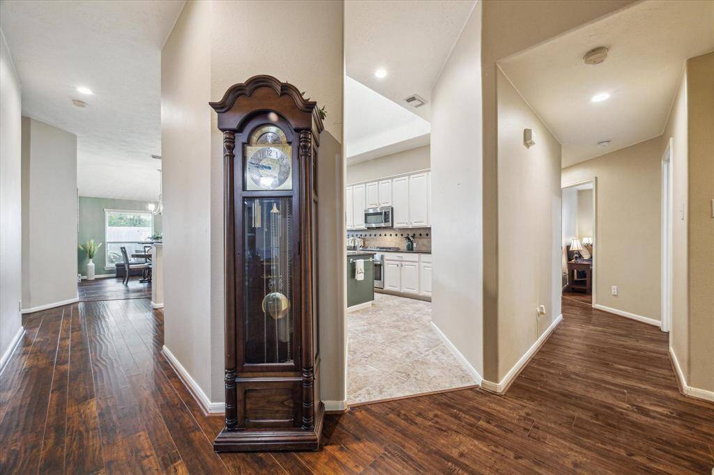 Spacious kitchen with stainless appliances and a central island with a sink.
